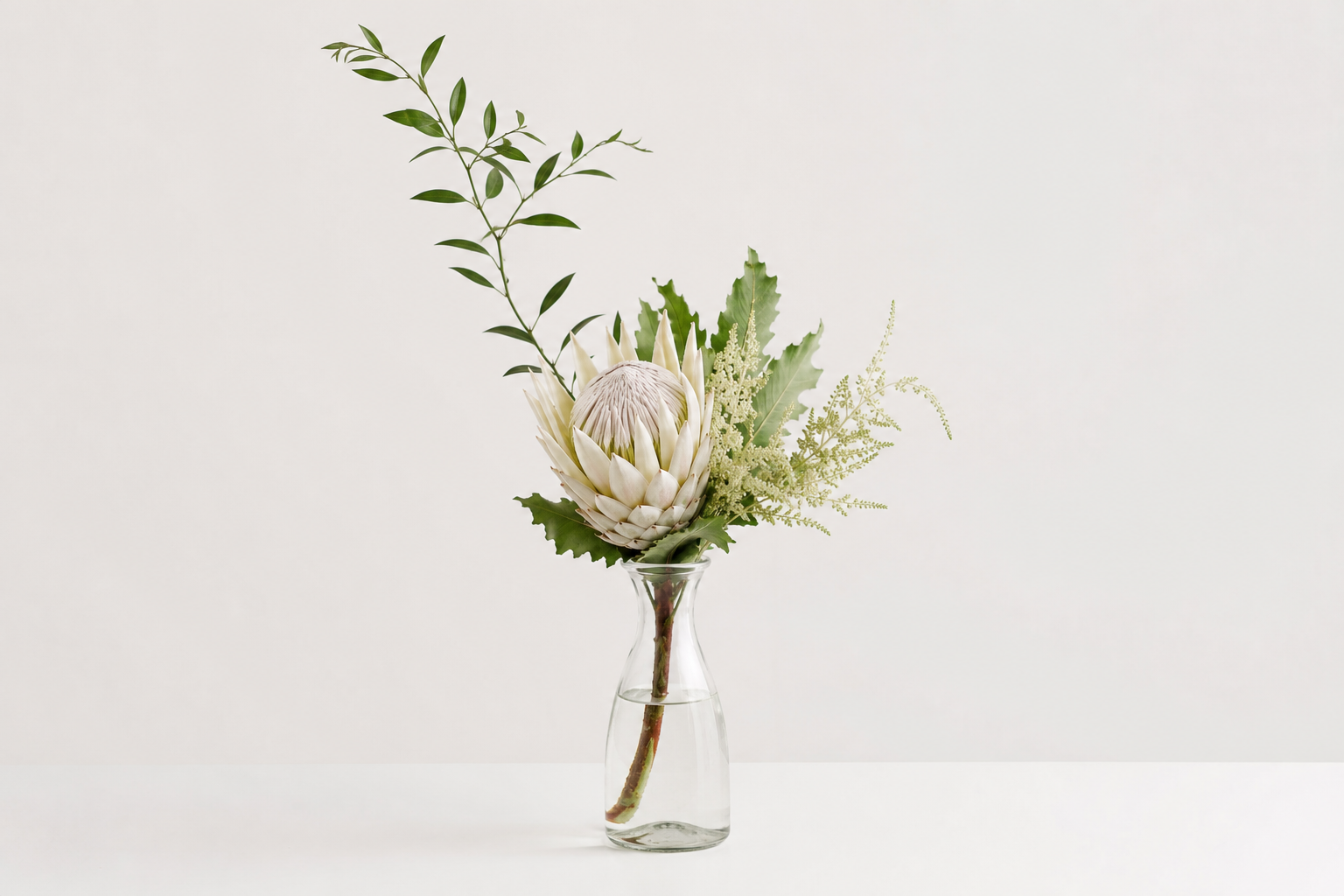 Minimal single-stem arrangement in glass vase